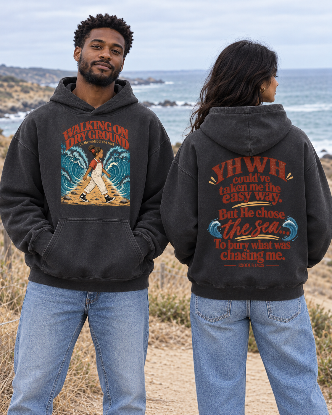 Front and back lifestyle mockup of the charcoal Walking on Dry Ground hoodie on a coastal trail
