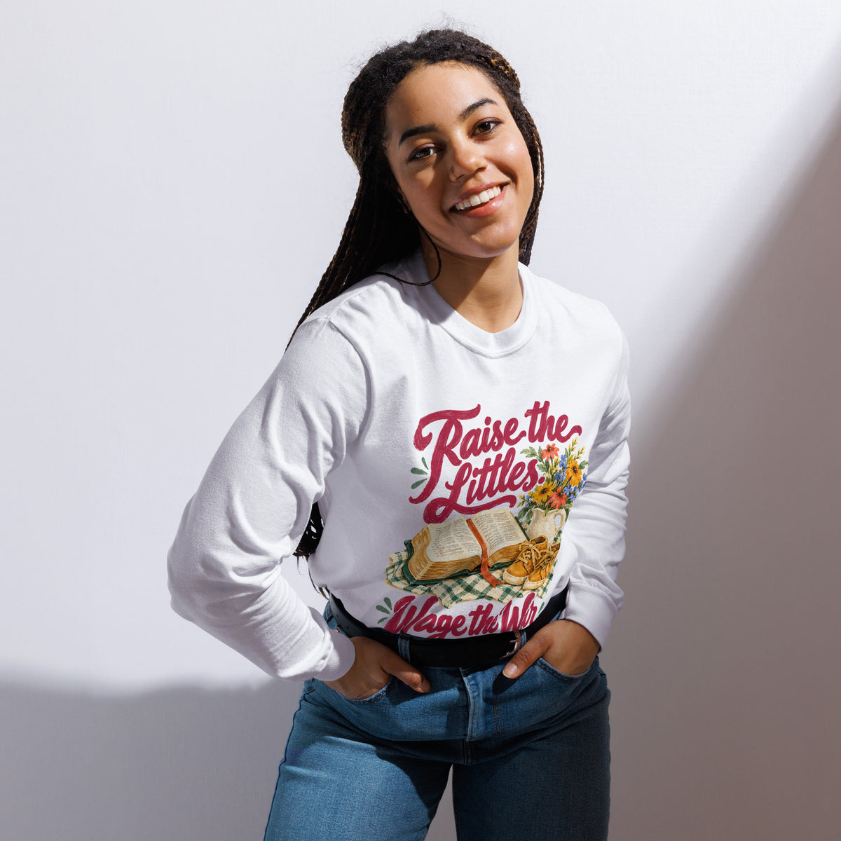 Woman modeling the white Raise the Littles, Wage the War garment-dyed long-sleeve tee